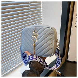 Blue quilted square bag with gold S-logo, tassel detail and lettered wide shoulder strap