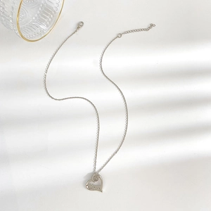 Detailed view of silver heart necklace with Mom letter engraving and sparkling crystal inlay