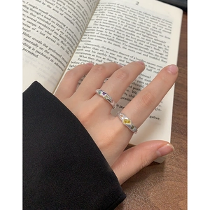 S925 sterling silver geometric ring with colorful zircon stones on book background