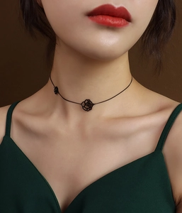 Close-up of elegant 18K gold-plated rose flower pendant necklace on a female neck