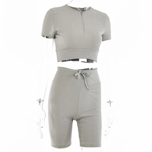 Detail of grey ribbed knit two-piece set featuring half-zip crop top and drawstring shorts
