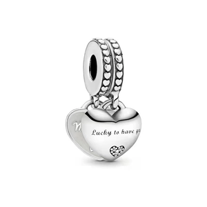 Macro detail of silver double-heart pendant engraved with Lucky to have you text