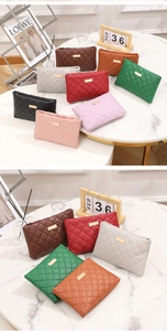 Flat lay of colorful quilted PU leather mini crossbody bags on marble background