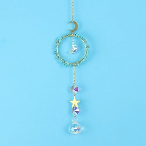 Detail of golden moon and star suncatcher with turquoise stones and crystal prism