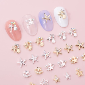 Starfish and shell nail art charms with pearls and rhinestones on colorful nail tips