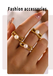 Close-up of three gold hollow square rings with pearls on model's fingers