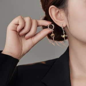 Thai silver retro crown cross earrings with twisted hoop design on professional female model