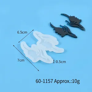 Macro shot of wing-shaped heart silicone mold with blue resin casting for DIY crafts