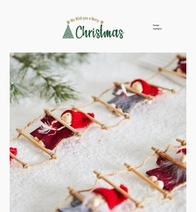 Detail of Santa Claus figurines on a wooden rope ladder against a snowy white background