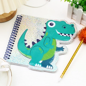 Detail of cute green dinosaur PVC bubble cover with laser finish on a spiral notebook