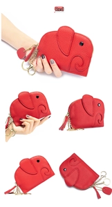 Detail of red elephant-shaped leather coin purse with golden hardware and tassel