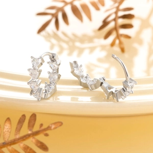 Silver-plated hoop earrings featuring sparkling heart-shaped cubic zirconia stones