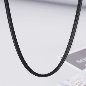 Close-up of 5mm black flat snake bone chain necklace with sleek minimalist texture