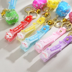 Detail view of lucky cat floating liquid keychains with colorful glitter and golden bells