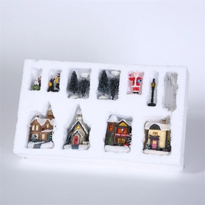10-piece Christmas village set with LED houses and figurines in packaging