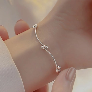 Minimalist silver beaded knot bracelet for women with sleek metallic bead accents