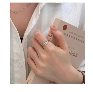 Detailed view of silver multi-layered star ring with zircon on model's finger