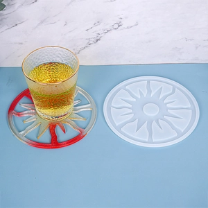 Detail of sunburst silicone mold and finished resin coaster on marble background