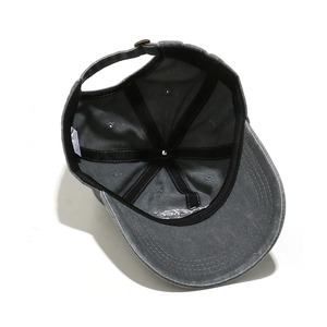 Detail view of cotton baseball cap interior with sweatband, seams, and metal buckle