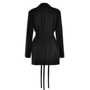 Detail view of the back of a black belted blazer dress with stylish long fringe tassels