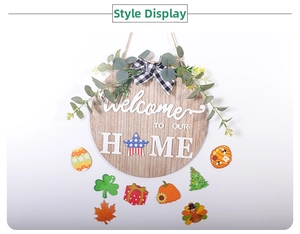 Detail of wooden welcome sign with interchangeable holiday icons and greenery