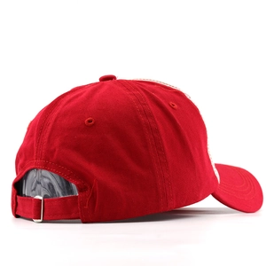 Détail de la boucle en métal réglable et de la sangle en coton rouge sur la casquette
