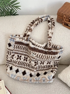 Retro plush tote bag with geometric patterns on a soft sofa in a cozy interior setting