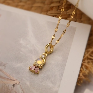 Detailed view of gold plated princess pendant with pink zircons and moonstone