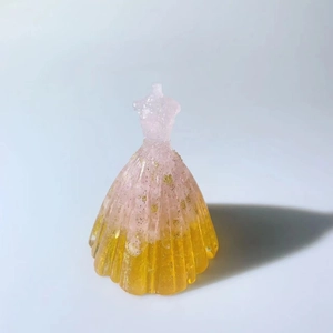 Detail of pink and yellow gradient resin dress figurine with sparkling gold glitter