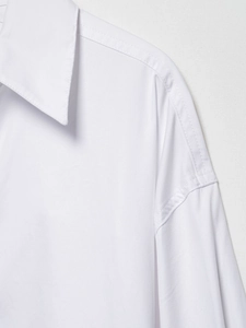 Detail shot of white cotton twill shirt collar and shoulder with precise stitching