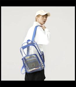 Detail view of transparent PVC backpack showing side mesh pocket and blue woven strap