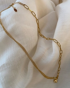 Close-up of asymmetrical 18K gold plated chain necklace with a mini ball pendant