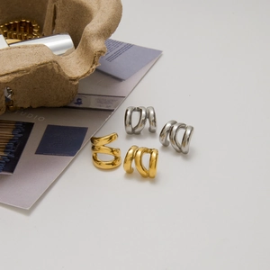 Classic 14K gold and silver triple layered curved cuff earrings in a minimalist style