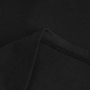 Macro detail of high-quality double-needle stitching on black knit fabric dress