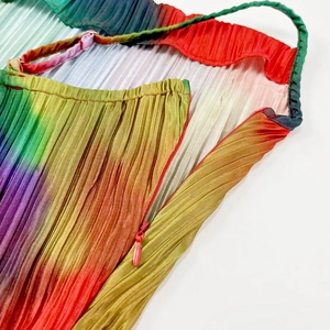 Macro shot of accordion pleats with rainbow gradient and invisible side zipper detail