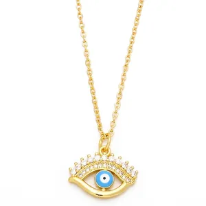 Golden Evil Eye necklace with clear zircon stones and blue center on cross chain
