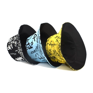 Graffiti print bucket hats in black, light blue, and yellow for street fashion style