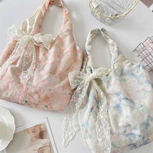 Detail of Korean style tote bag featuring lace bows and watercolor floral embroidery