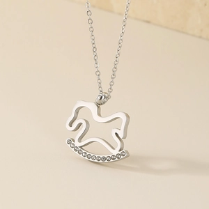 Detail of silver rocking horse necklace pendant with sparkling rhinestones on chain
