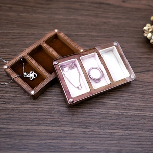 Walnut wood jewelry box with three compartments and soft velvet lining for rings and necklaces