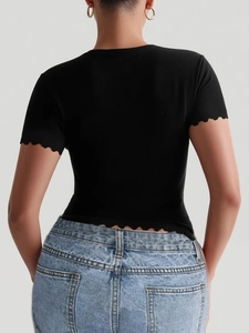 Detail view of the lettuce trim hem and sleeve design on a black slim fit yoga T-shirt