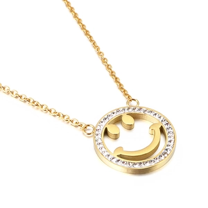 Elegant gold-plated smiley face necklace with sparkling crystals on a white background
