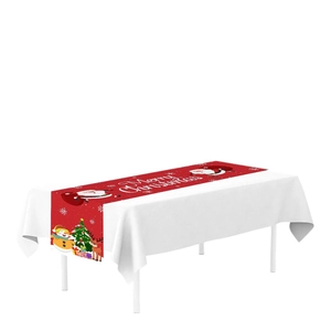 Red Christmas table runner with Santa, snowman and reindeer motifs on white tablecloth