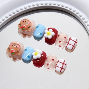 Detailed view of cute cartoon bear and floral patterns on press-on colorful toenails