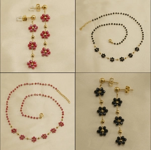 Detail of floral crystal necklace and earrings set in 18K gold plated stainless steel
