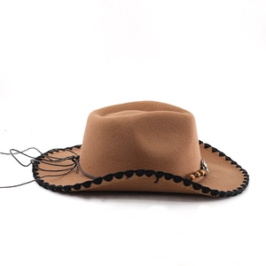 Detail of Western cowboy hat showing shell stitch brim and vintage bull head ornament