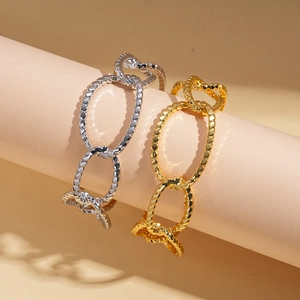 18K gold and silver plated oval link bracelets with textured metal finish on a stand