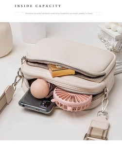 Top view showing inside capacity of off-white crossbody bag with phone and cosmetics