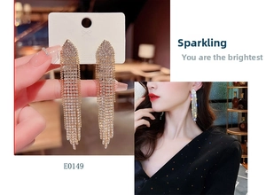 Detail of silver long tassel earrings with sparkling rhinestones for evening wear