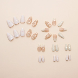 Press-on nail set with almond shape, pink bows, lace patterns, and French tip designs
